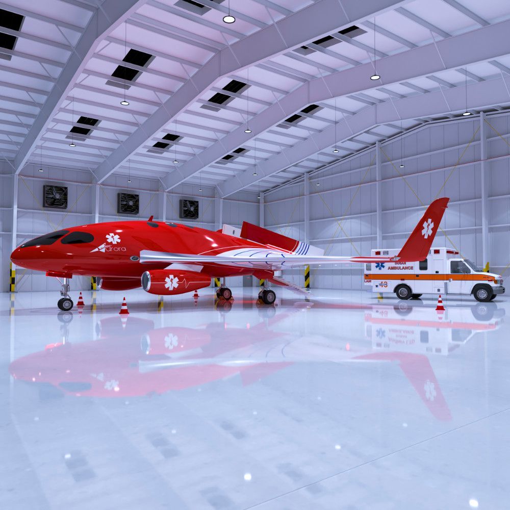 Red medical aircraft in a white hangar, ambulance nearby.