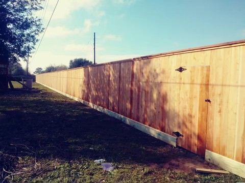 houston wood fence in a backyard with a shadow of a tree cast on the fence