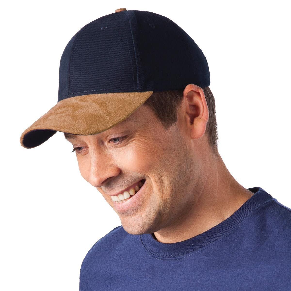 A man wearing a baseball cap and a blue shirt smiles