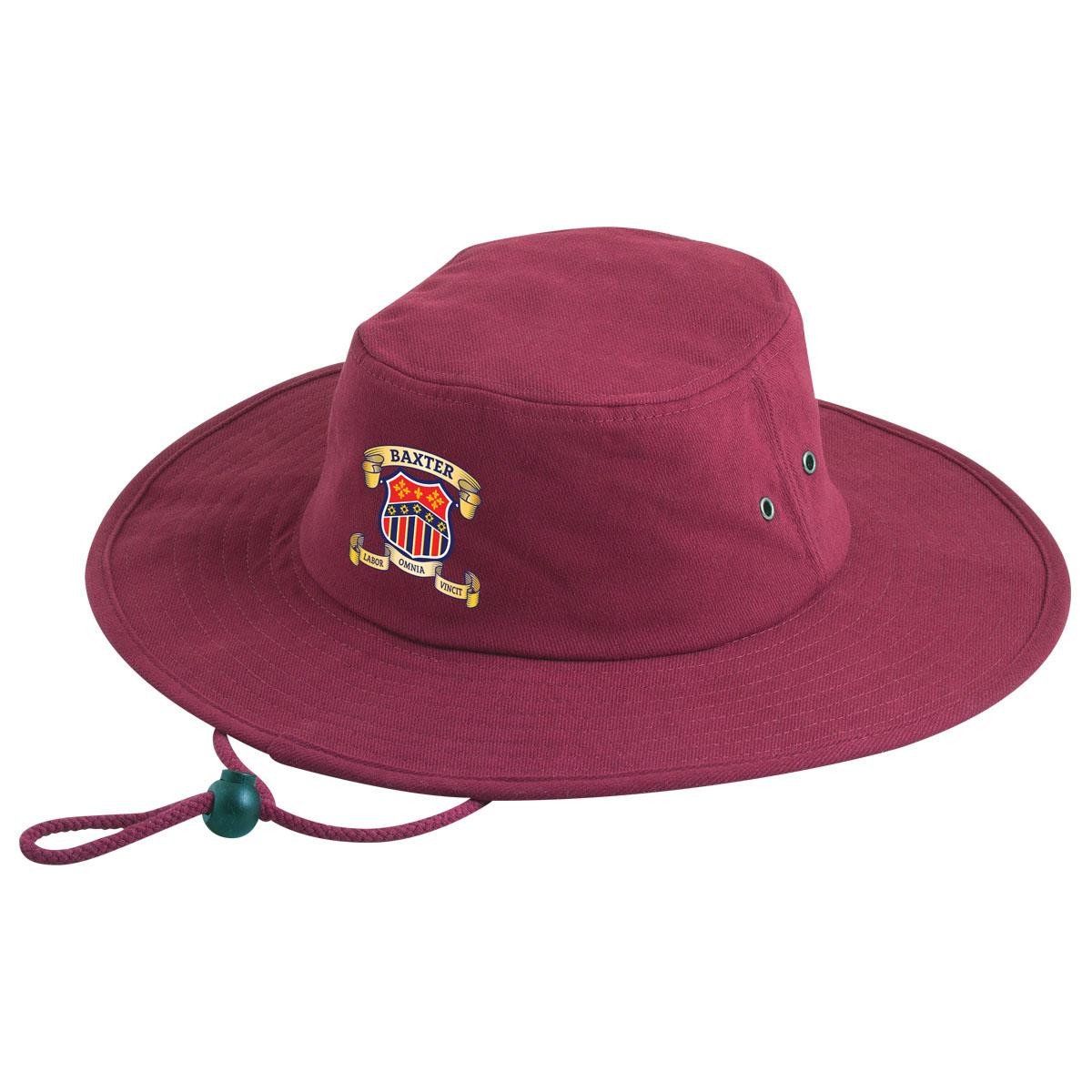 A maroon hat with a crest on it