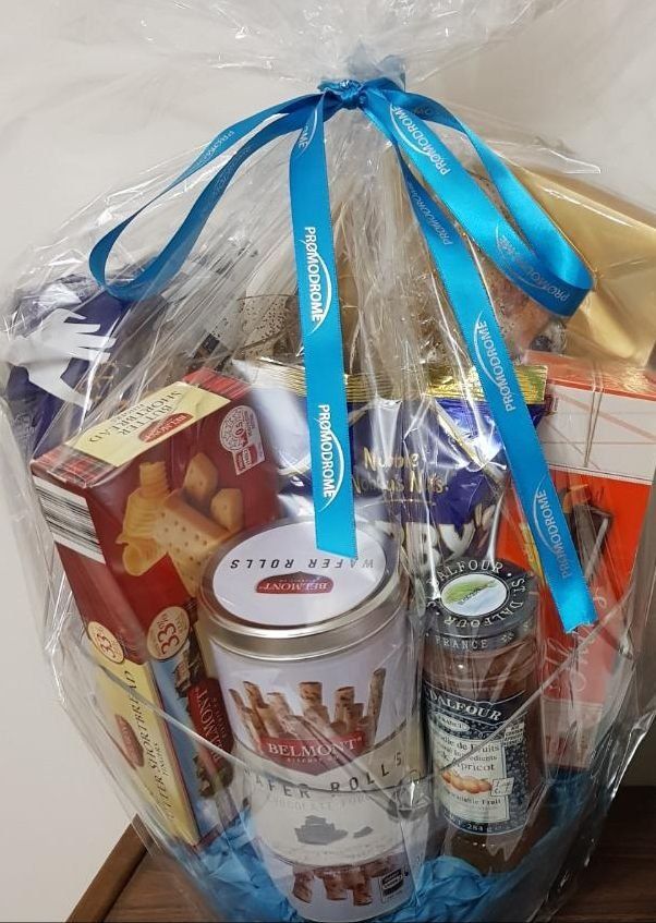 A basket filled with lots of food and a blue ribbon.
