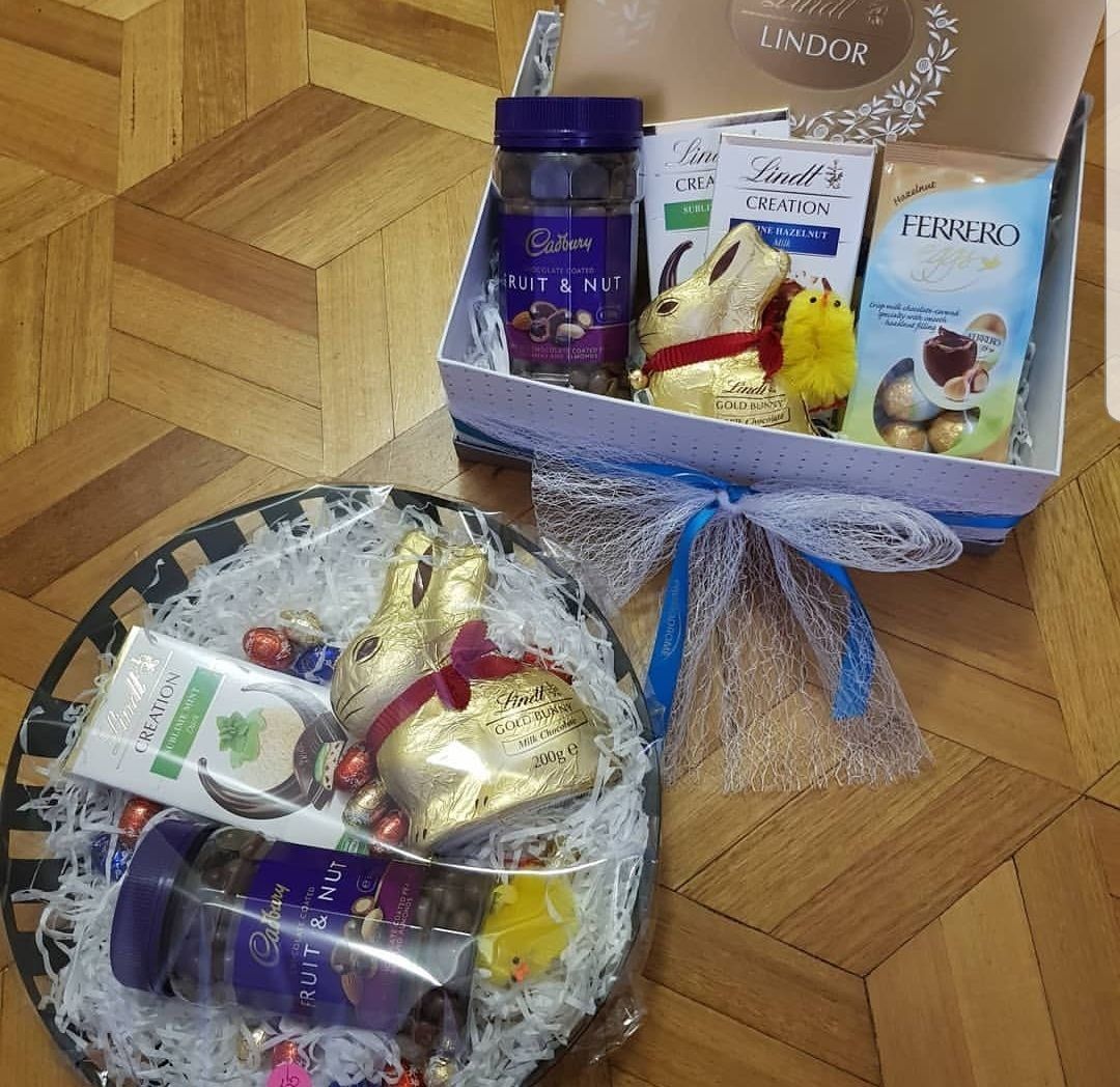 A box of lindt chocolates sits on a wooden table