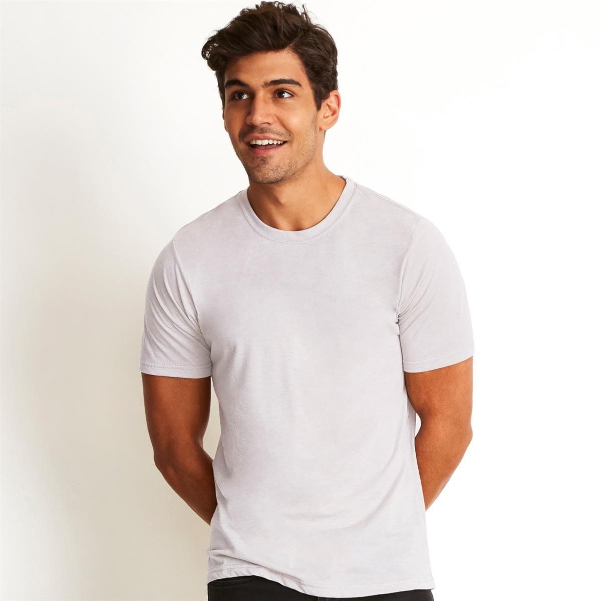 A man wearing a white t-shirt with his hands in his pockets
