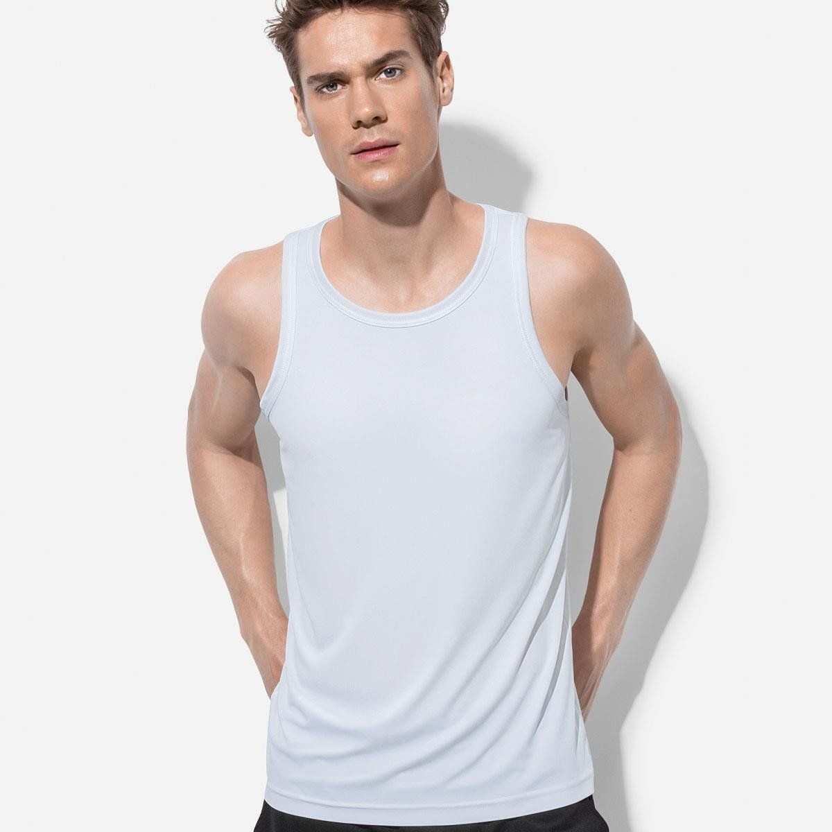 A man is wearing a white tank top and black shorts