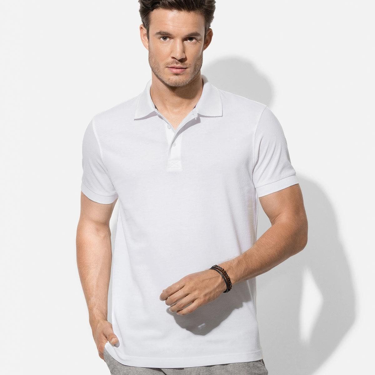 A man wearing a white polo shirt and grey shorts