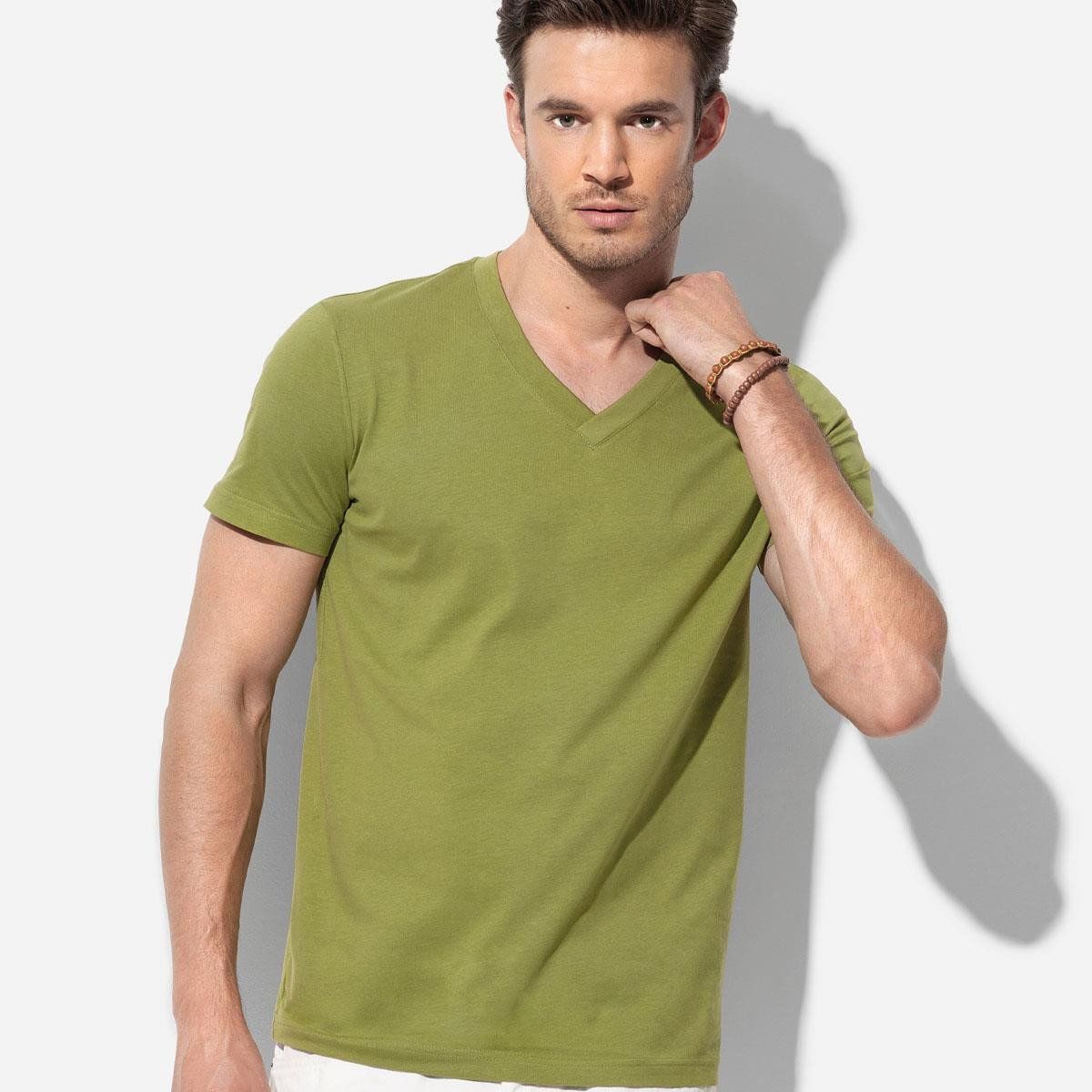 A man wearing a green t-shirt with a v-neck