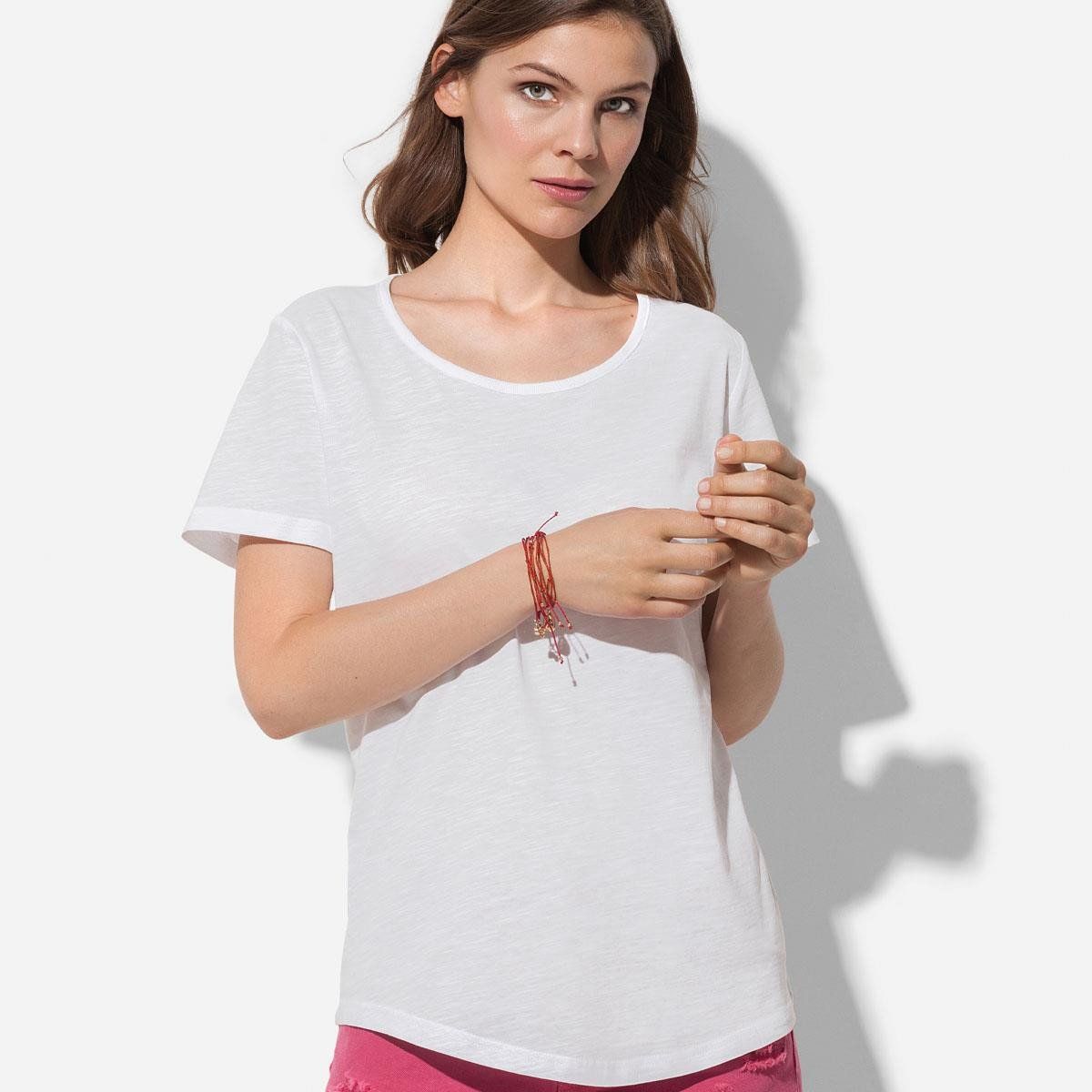 A woman is wearing a white t-shirt and pink shorts