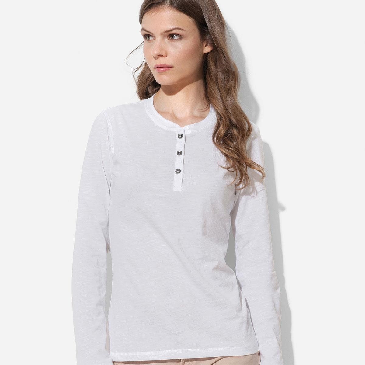 A woman wearing a white shirt with long sleeves and buttons