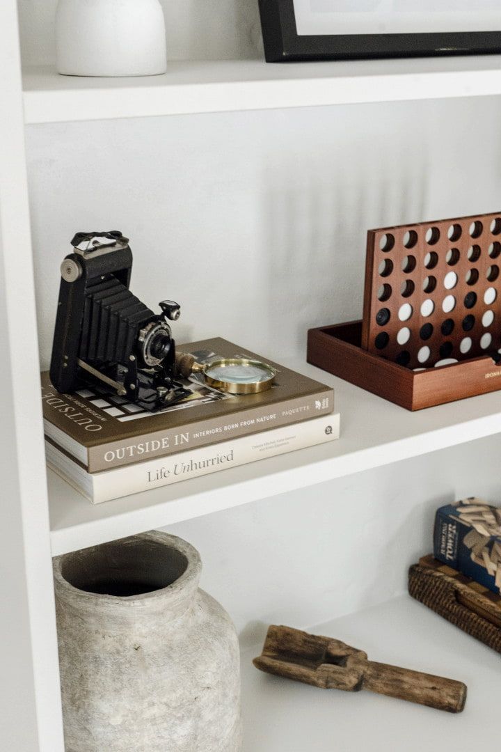 White Bookshelf With Decorative Items — Stark Building & Constructions In Berry, NSW