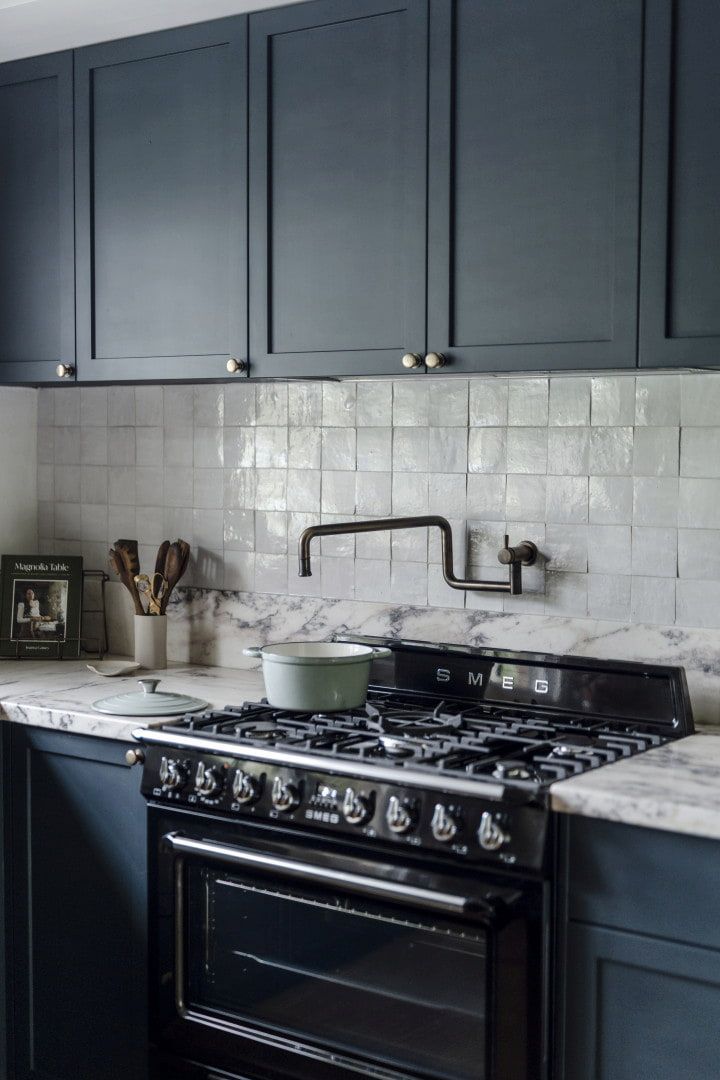 Dark Blue Kitchen With Black Stove and Marble Counters — Stark Building & Constructions In Berry, NSW