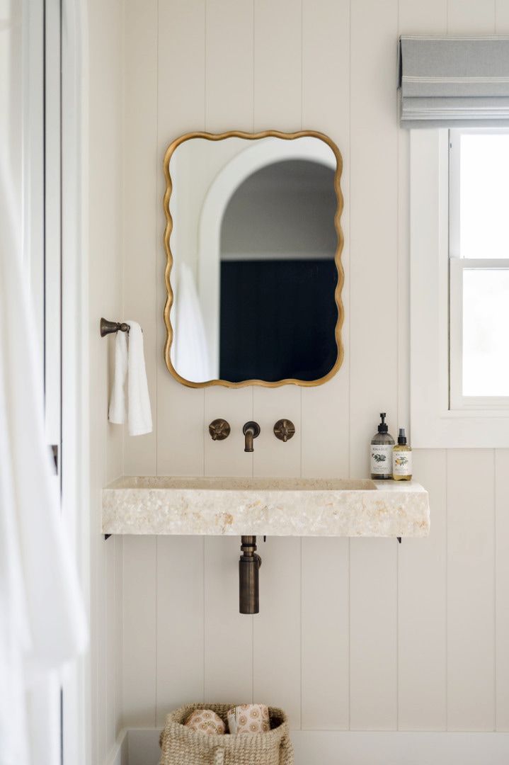 Beige Bathroom With a Stone Sink, Decorative Mirror, and Window — Stark Building & Constructions In Berry, NSW