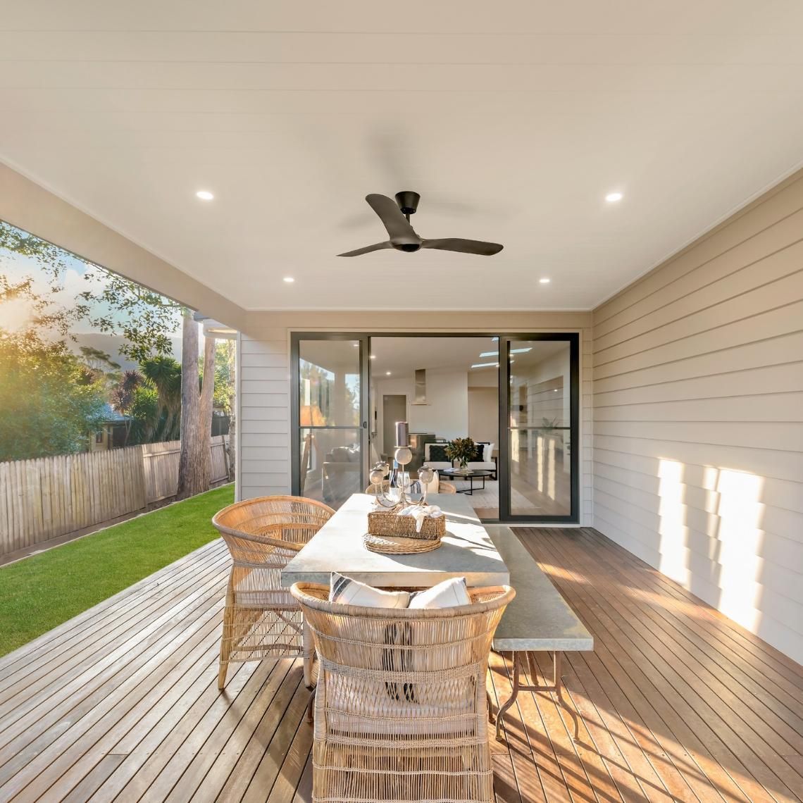 Outdoor Dining Area With Wooden Deck, Table, Chairs, and Ceiling Fan — Stark Building & Constructions In Nowra, NSW