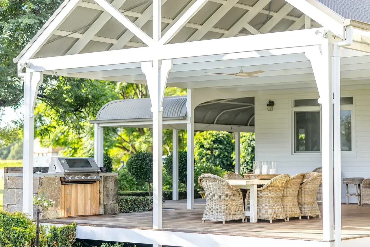 Outdoor Patio With a White Pergola, Grill, Table, Chairs — Stark Building & Constructions In Berry, NSW 