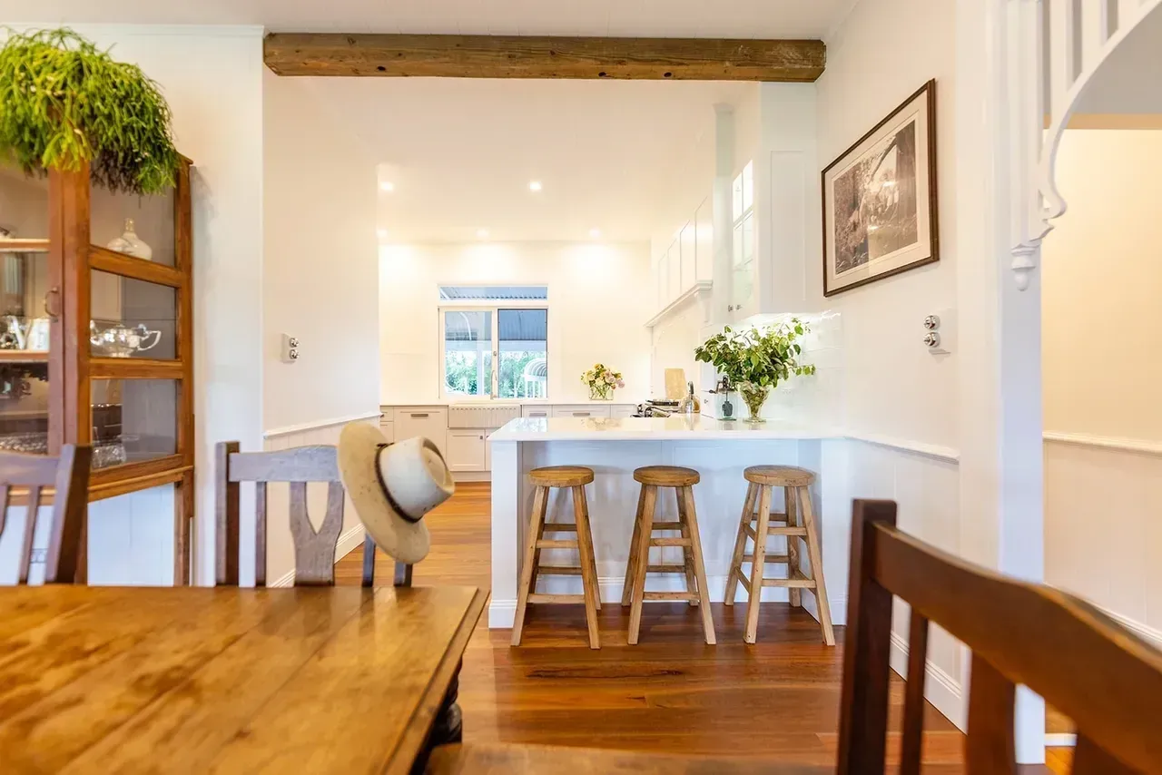 Wooden Dining Area With Kitchen in Background — Stark Building & Constructions In Shoalhaven, NSW
