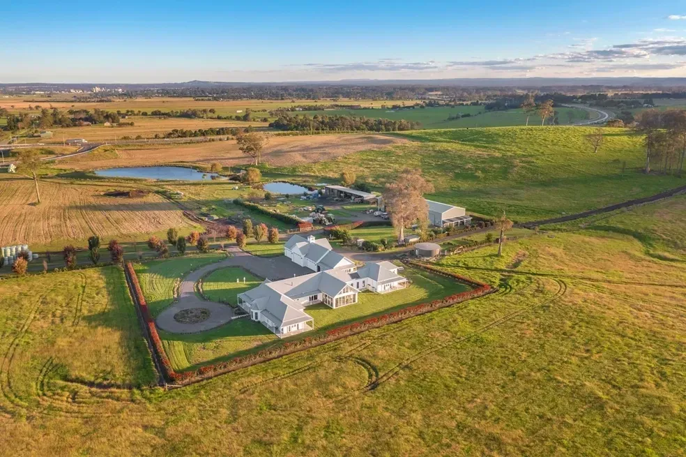 Aerial View of a Large White House With a Driveway — Stark Building & Constructions In Berry, NSW
