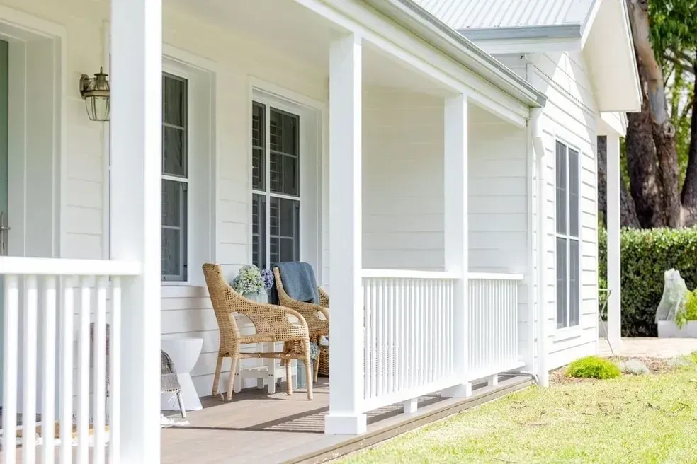 White Porch With Wicker Chairs, Overlooking a Green Lawn and Trees — Stark Building & Constructions In Berry, NSW