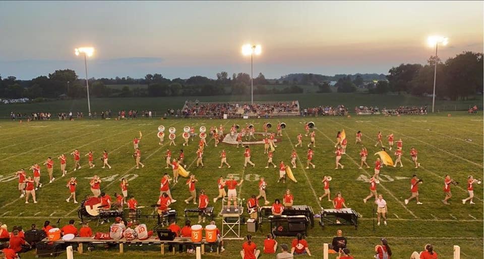 a marching band is performing on a football field