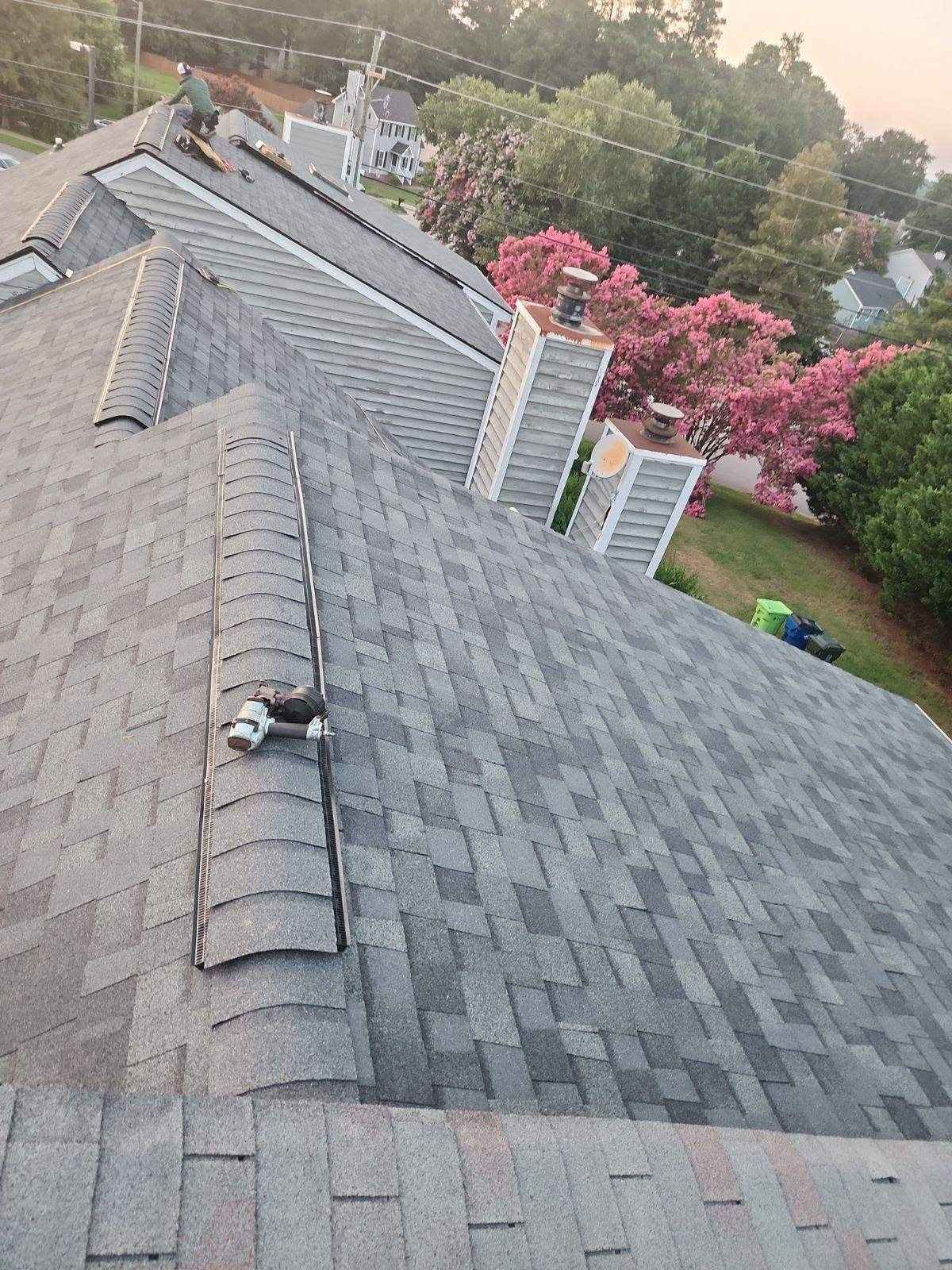 A person is working on the roof of a house.