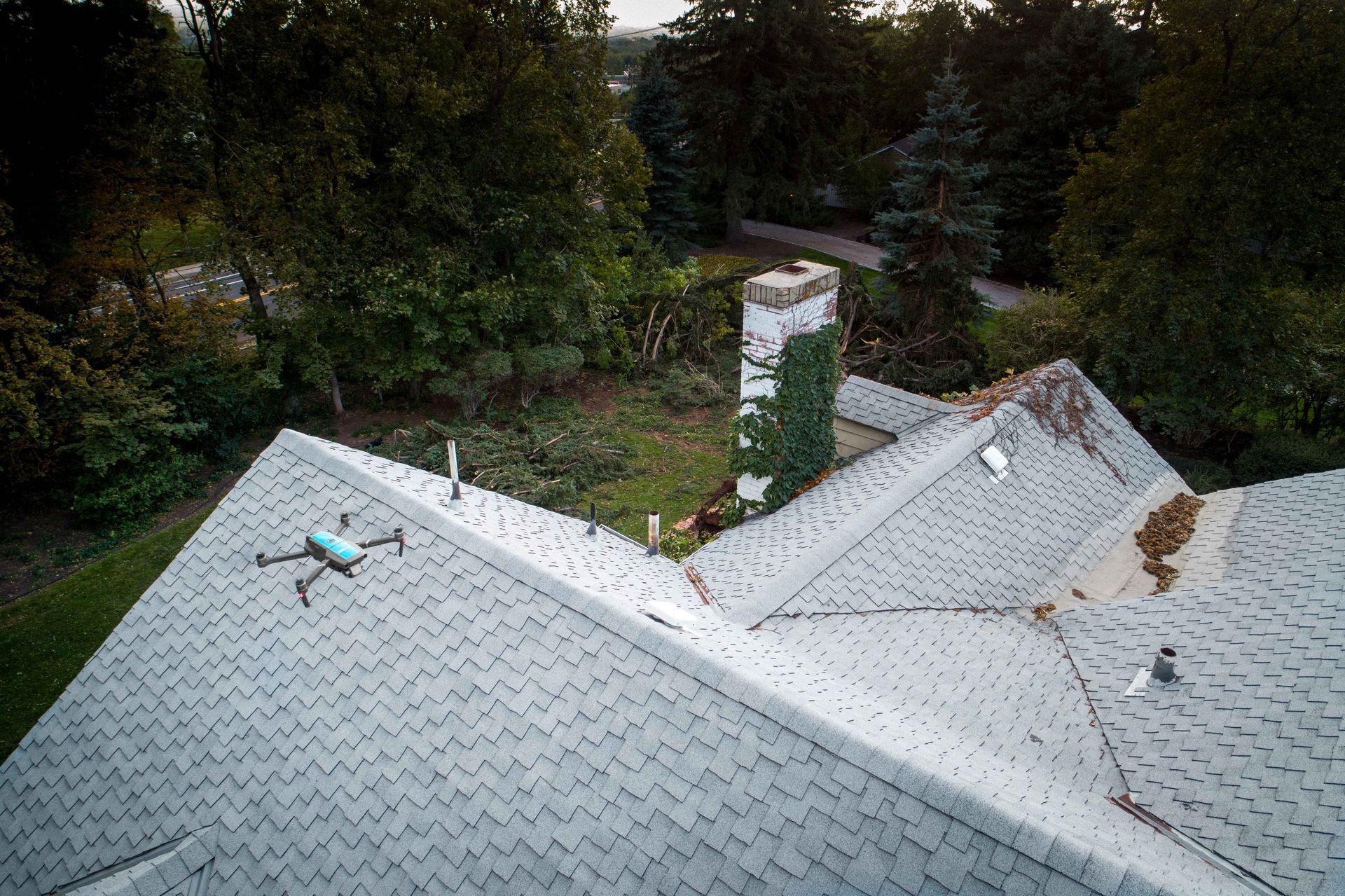 An aerial view of a roof with a drone flying over it.