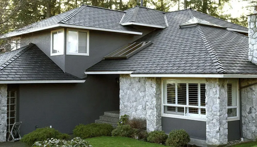 A large house with a gray roof and white windows