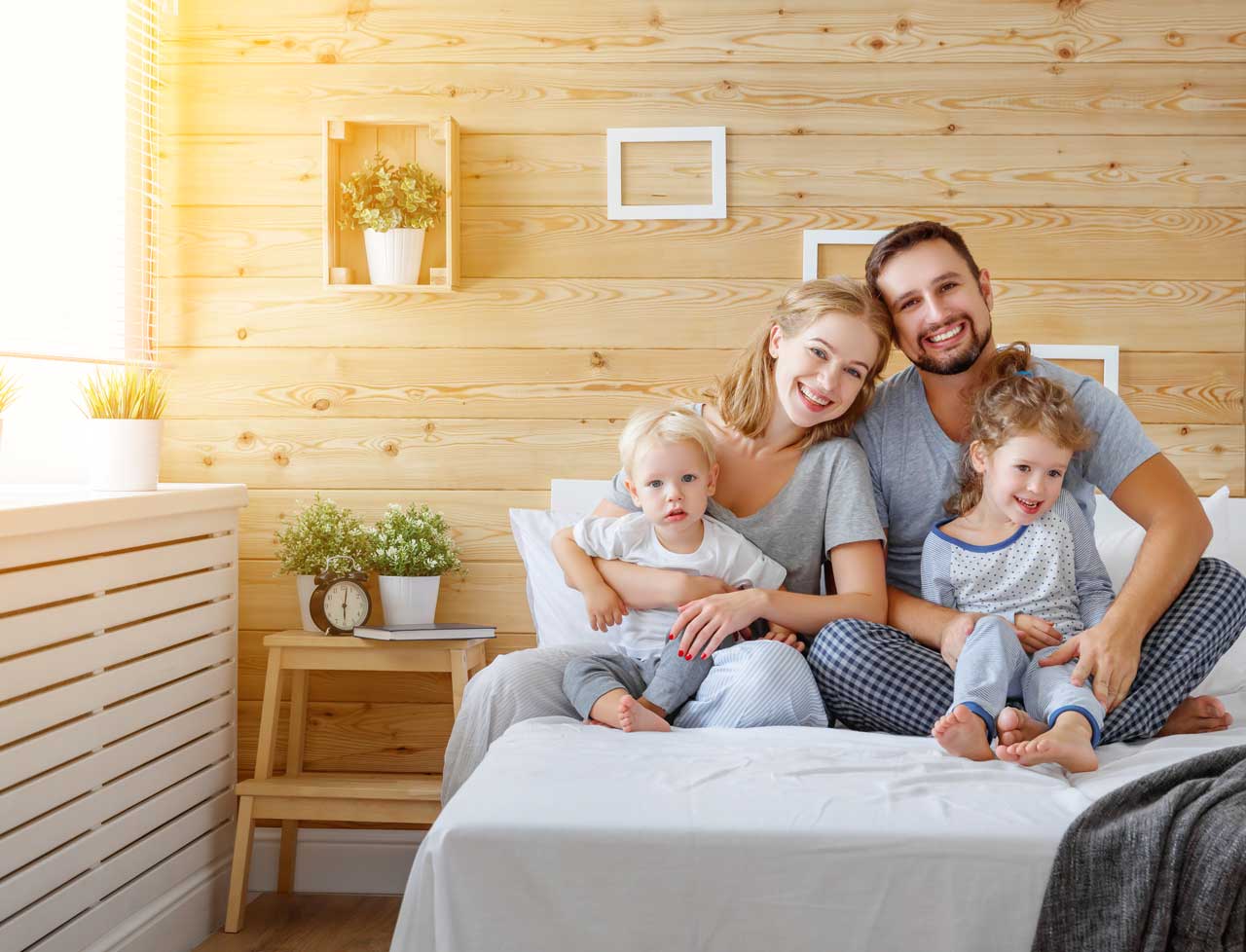 Happy-family-mother-father-and-children-daughter-and-son-in-bed