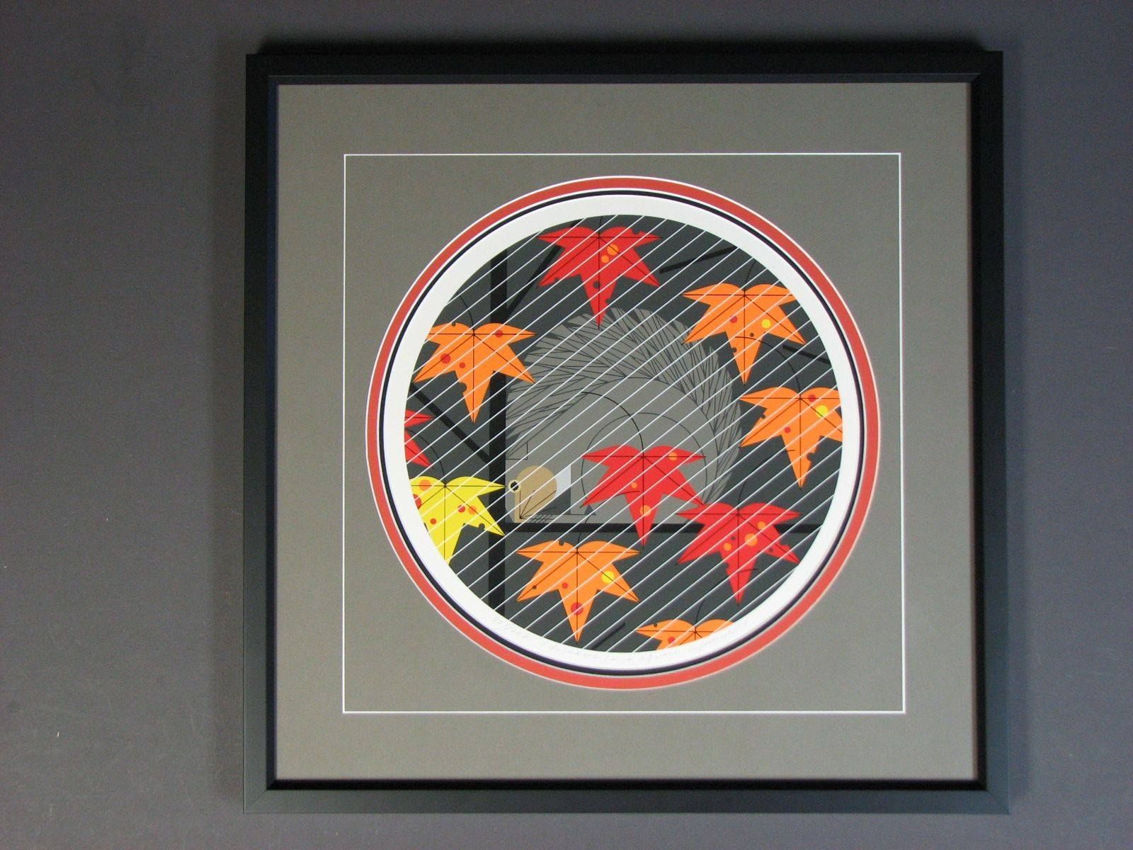 A framed picture of a circle with leaves on it