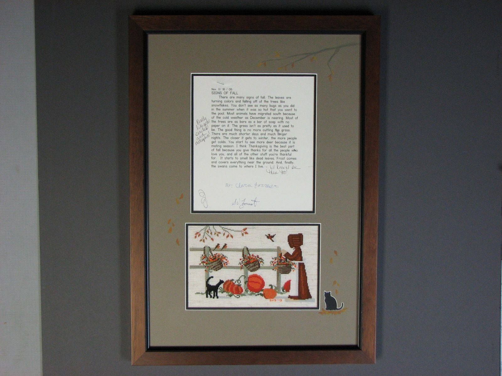 A framed picture of a letter and a picture of a cat