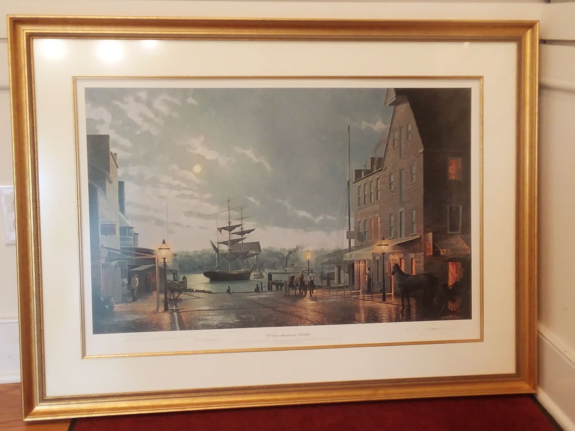 A framed picture of a ship in a harbor