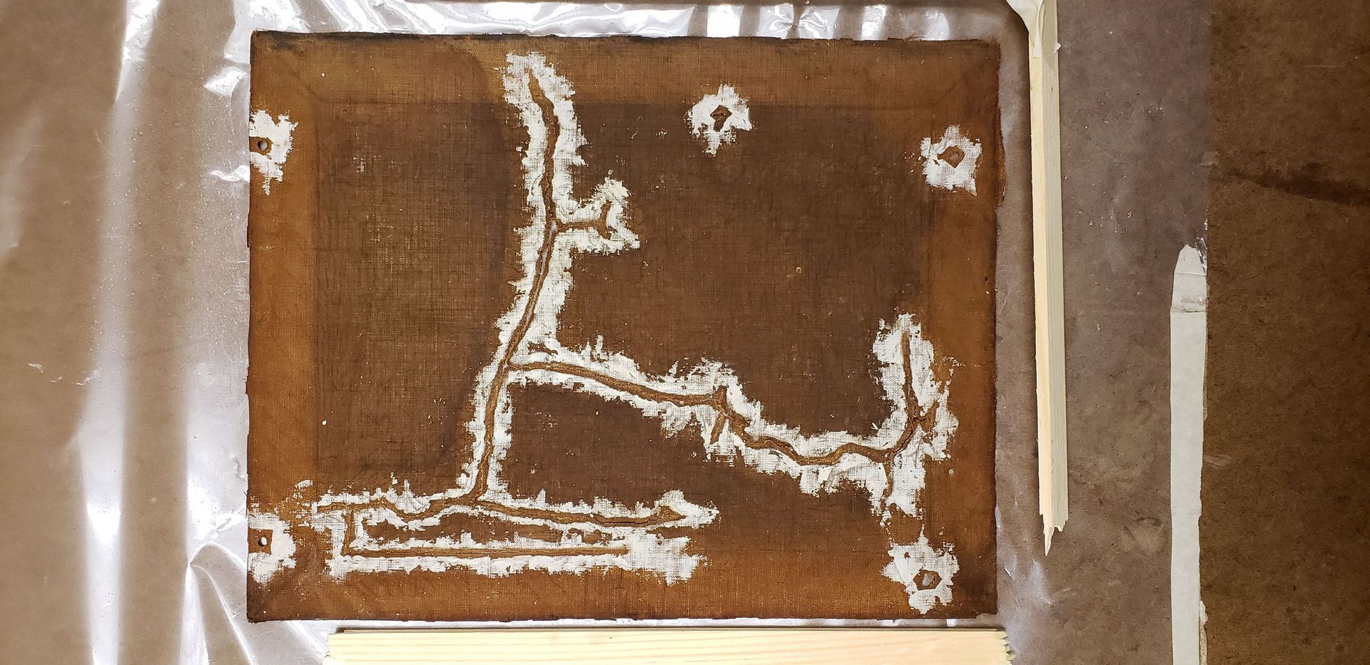 A piece of brown paper with a white drawing on it
