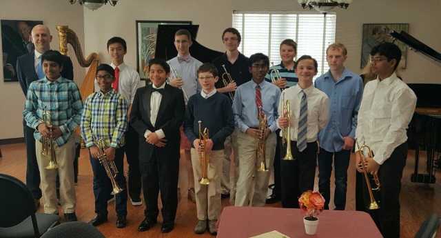 Group Of People Holding A Trumpet — Cary, NC — Cary School of Music