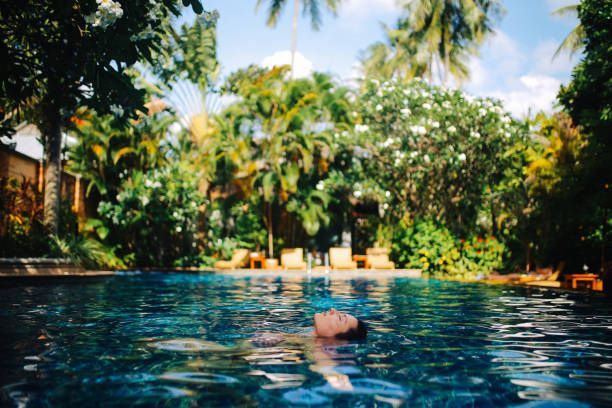 Young woman relaxing in the pool enjoying top-notch swimming pool maintenance by Pool Pro, Inc. in Kihei, HI.