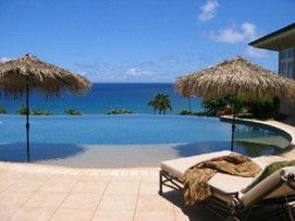 View of a modern swimming pool design in a beach setting.