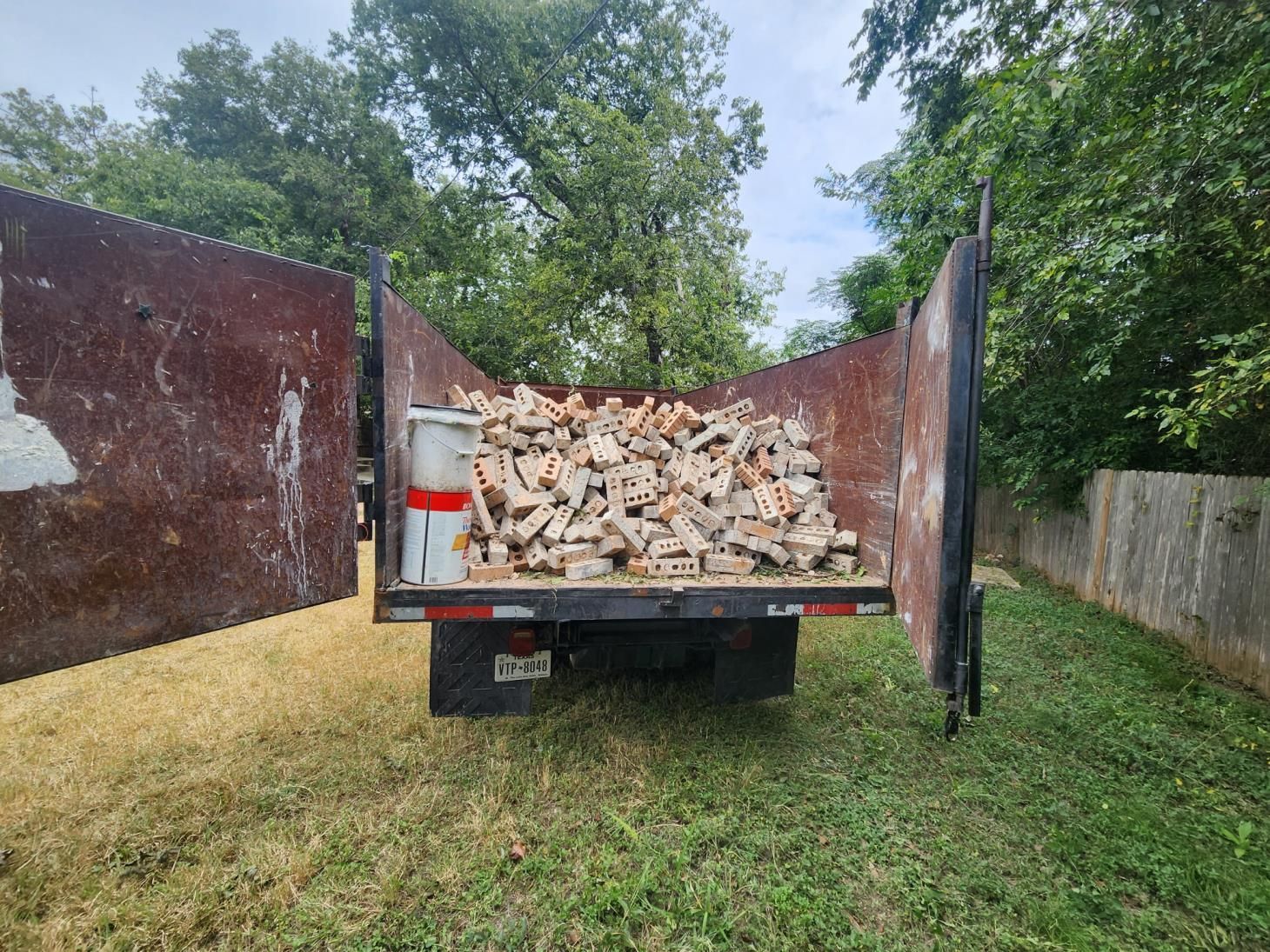 a pile of wood chips and a hammer on the floor .