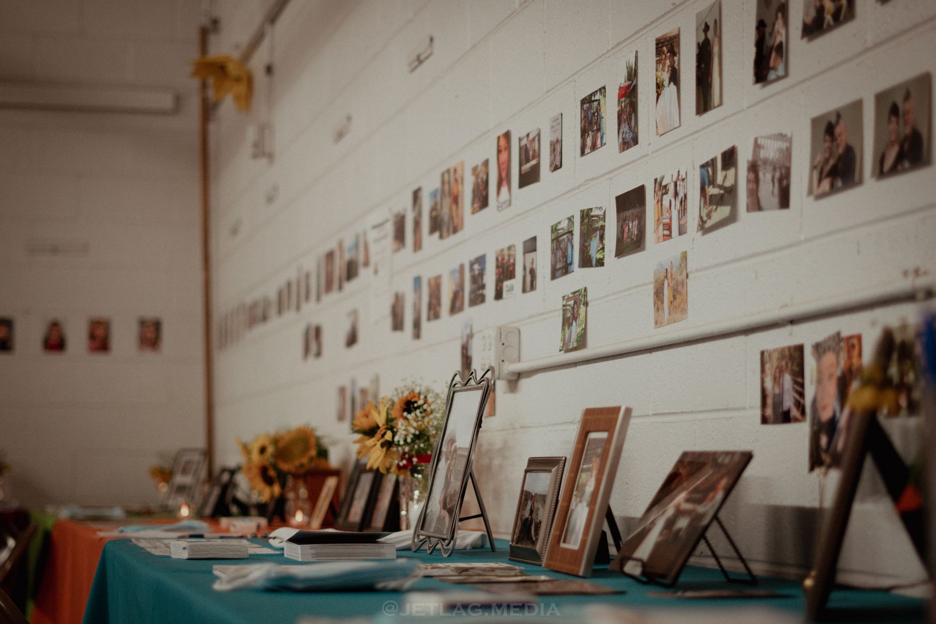 A table with pictures on it and a wall with pictures on it.