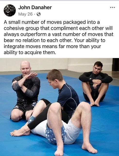 Picture of BJJ Black Belt, John Danaher coaching his students on the mat