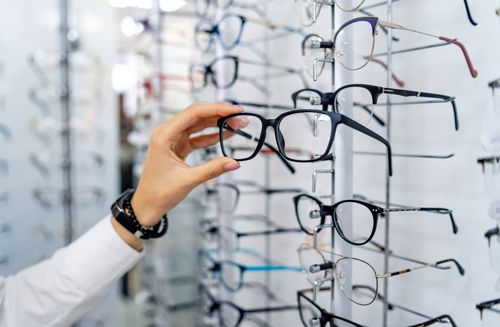 A Person Is Holding A Pair Of Glasses In A Store - Cheyenne, WY - Family Vision Center