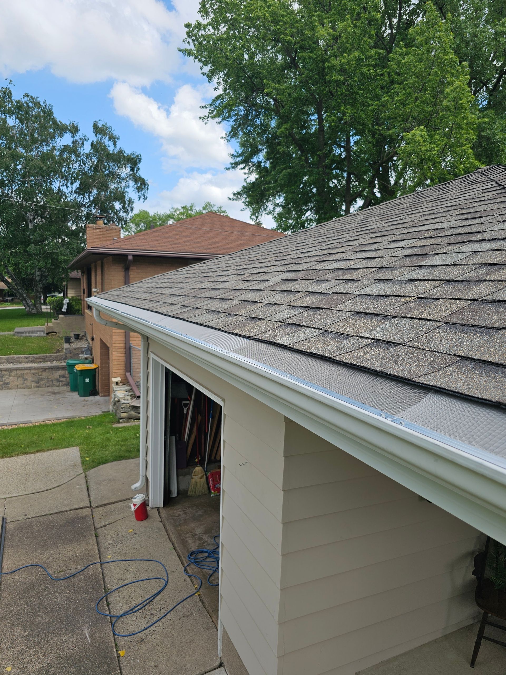 A house with a garage and a gutter on the roof.