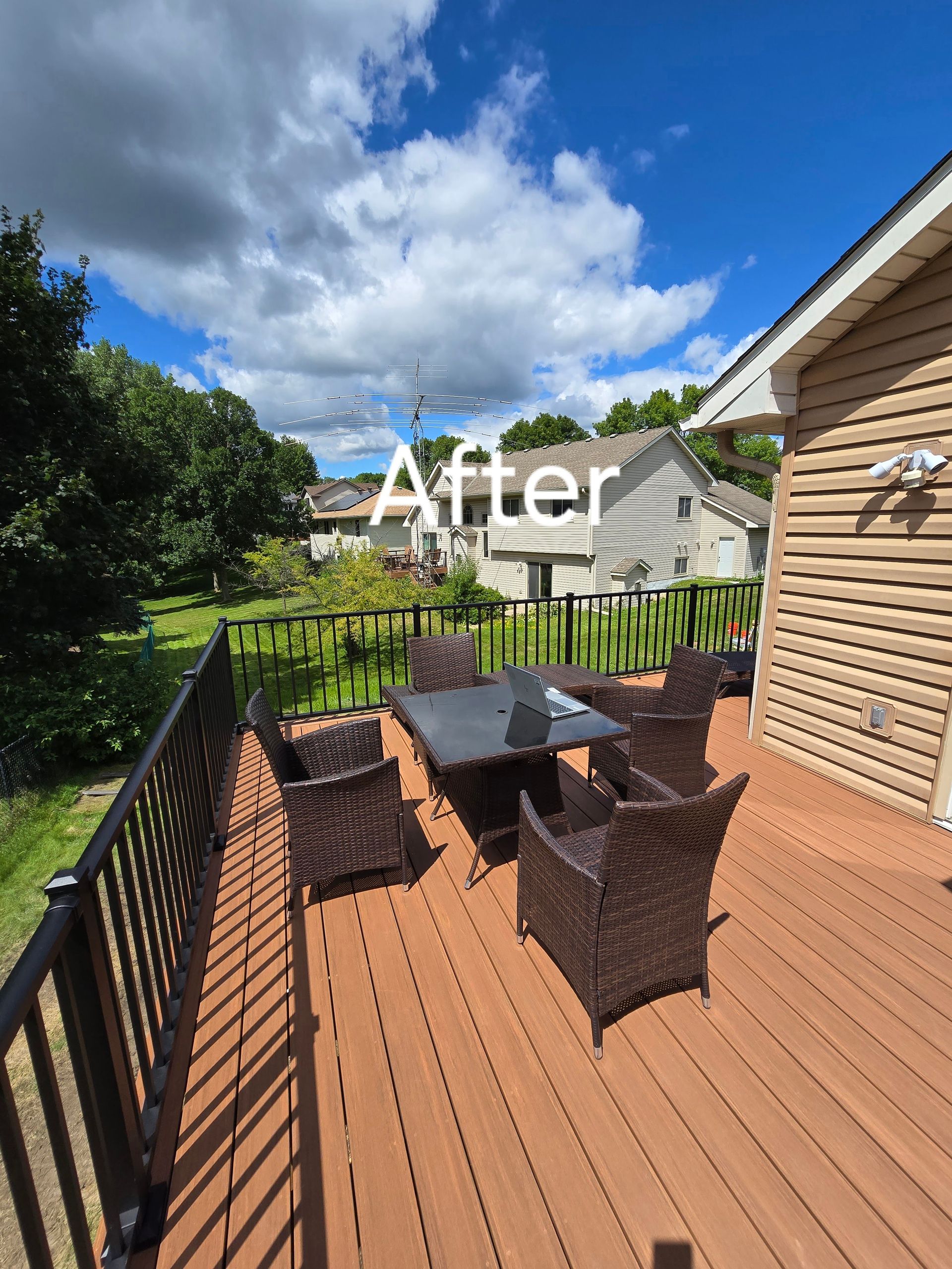 A picture of a deck with a table and chairs on it