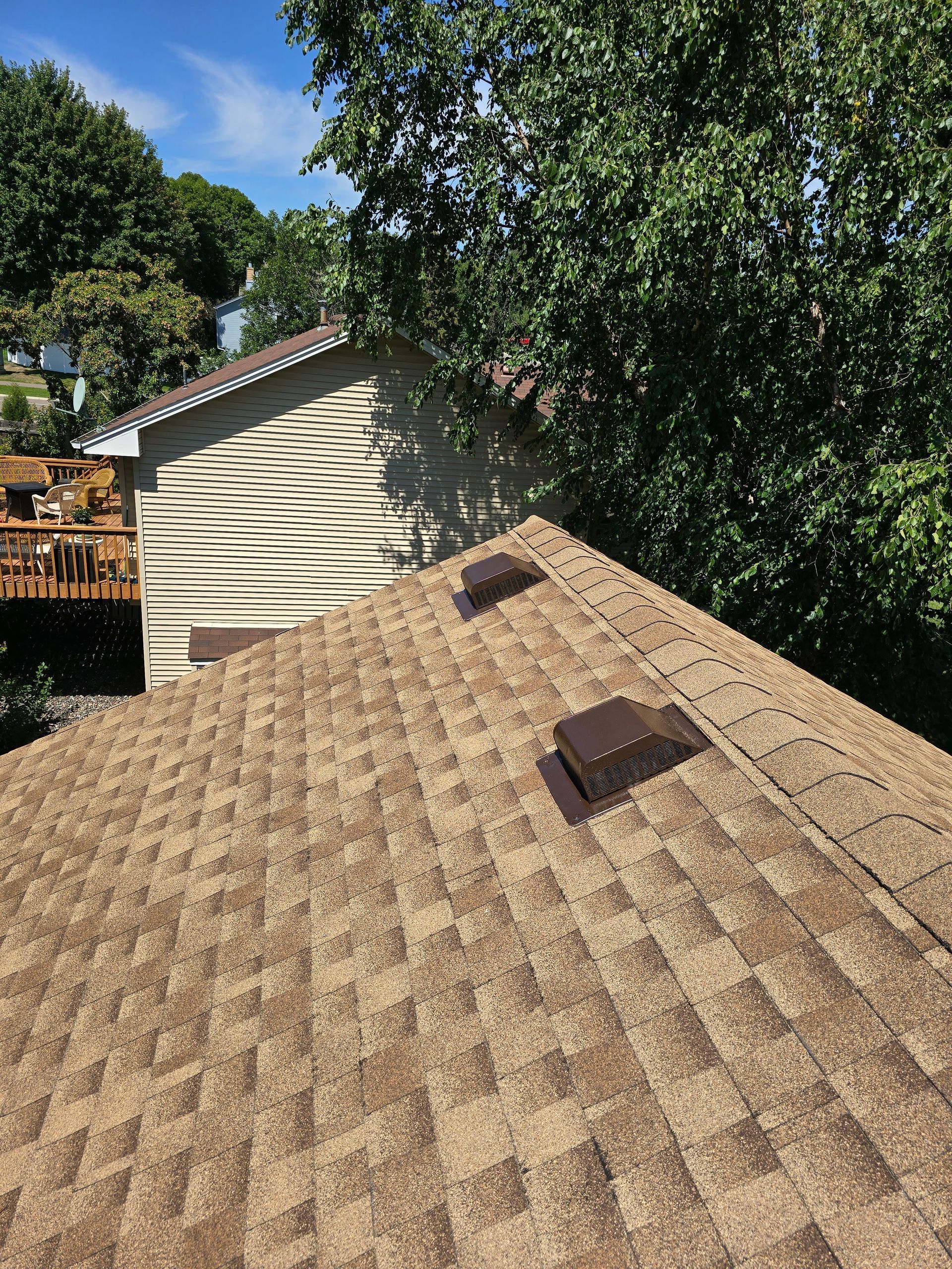 The roof of a house with a roof vent on it.