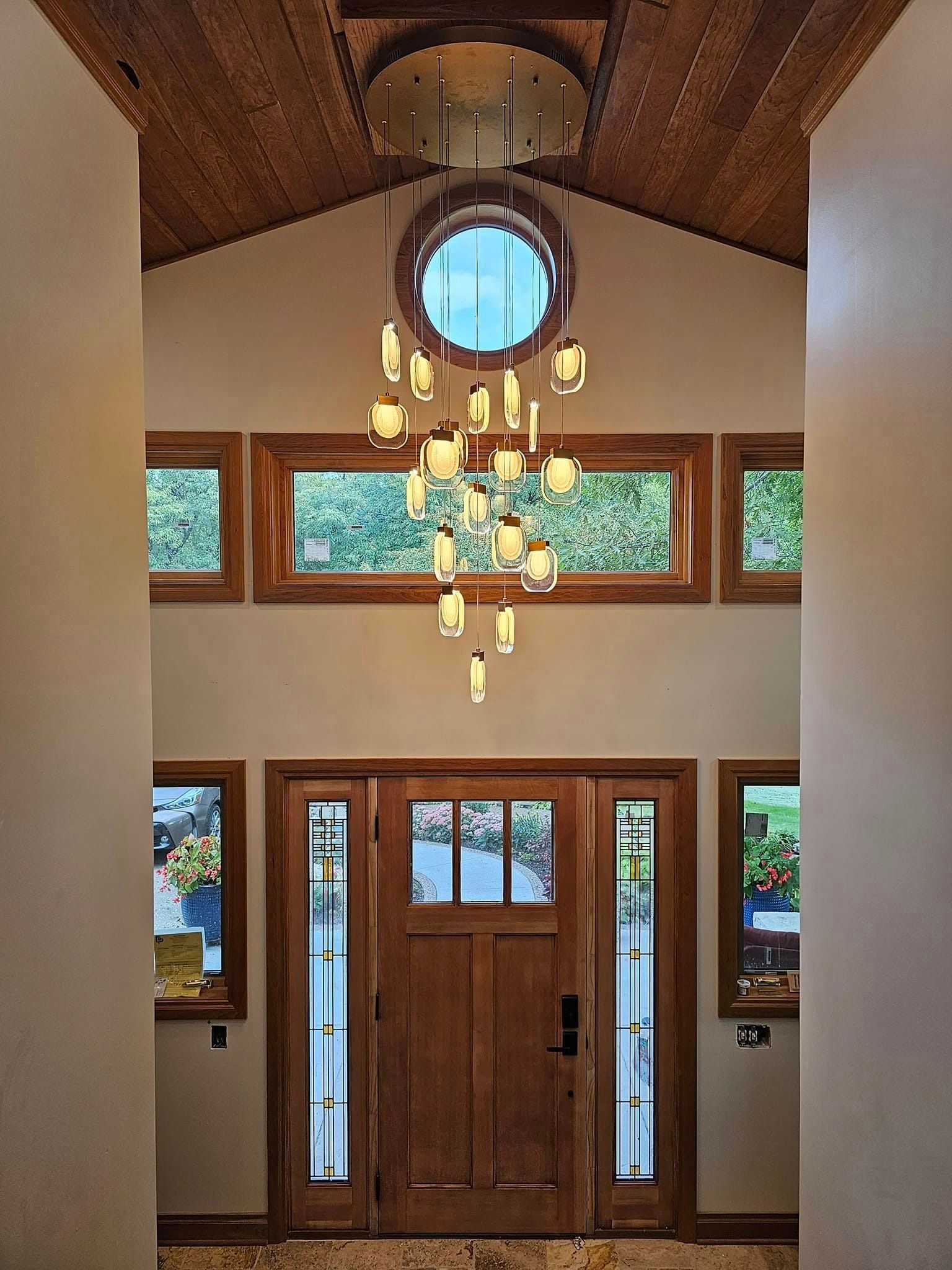 A large chandelier hangs from the ceiling above a wooden door