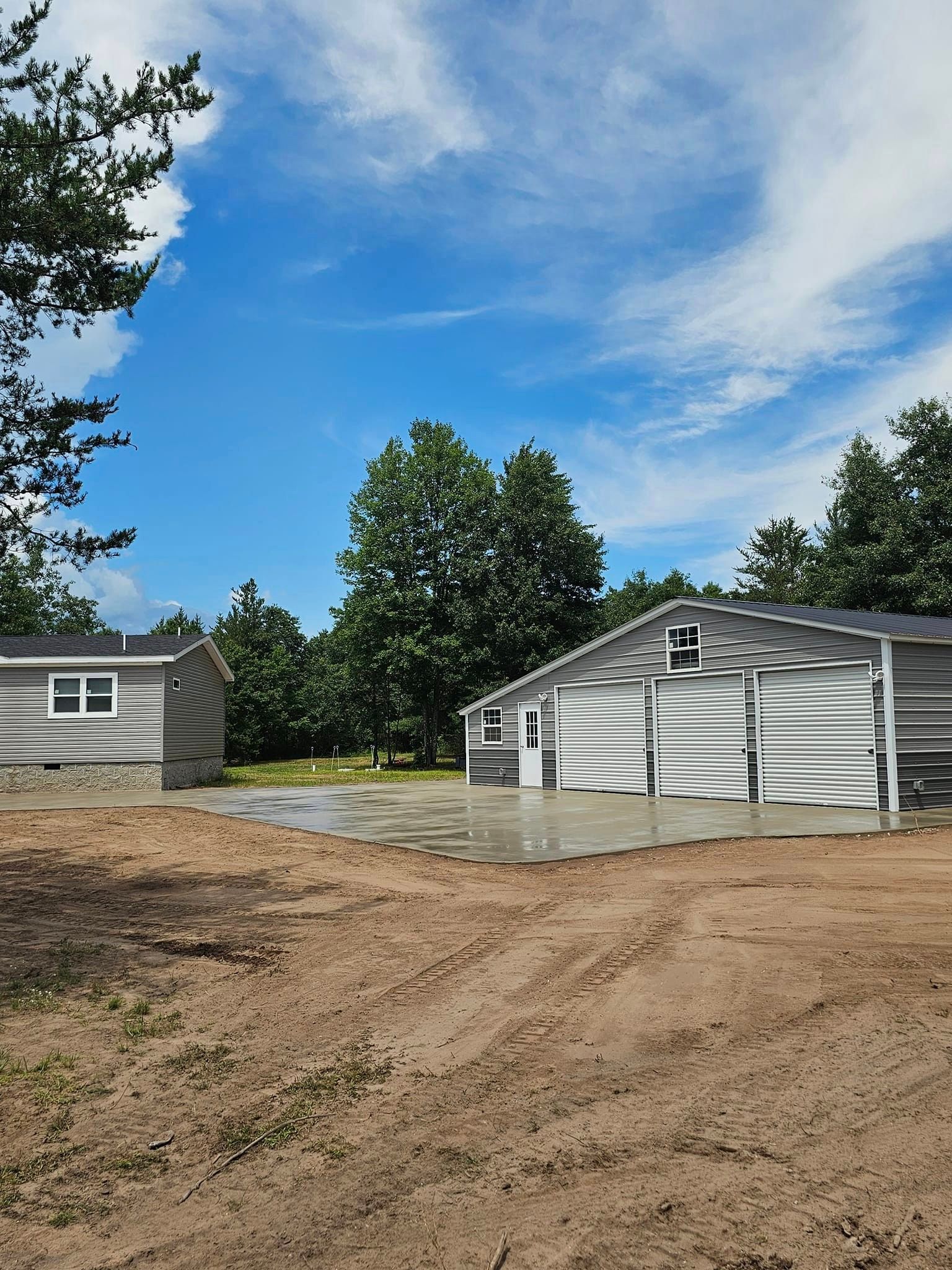 A couple of buildings are sitting next to each other in a dirt field.