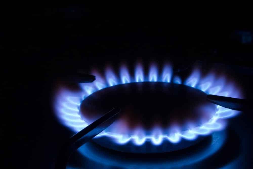 A Close Up of a Gas Burner With Blue Flames in the Dark — Cuttle Plumbing in Wollomombi, NSW