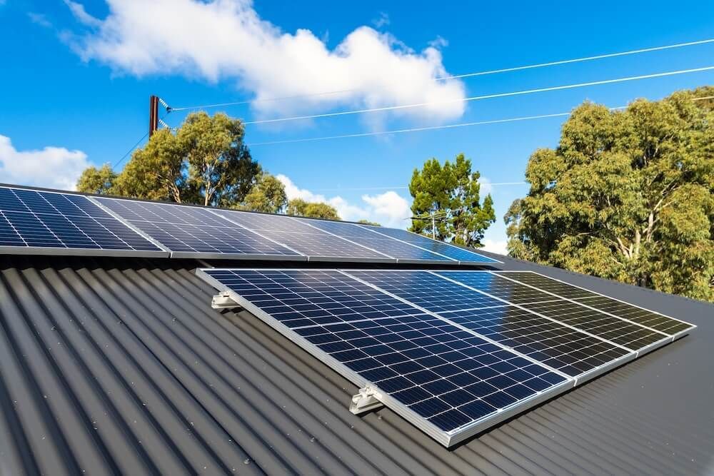 There are many solar panels on the roof of a house — J T Walker Electrical In Old Bar, NSW
