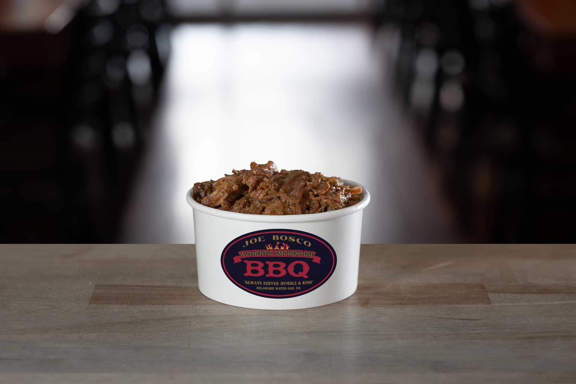 A white paper cup of pulled pork at Joe Bosco BBQ
