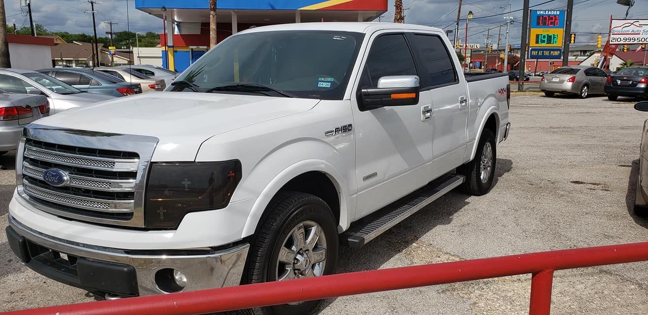 Sand dunes, tan and textured, with rippled patterns from the wind.