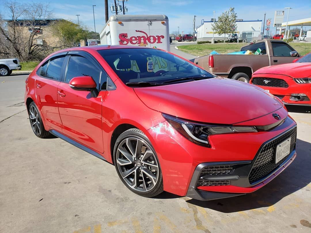 Sand dunes, tan and textured, with rippled patterns from the wind.