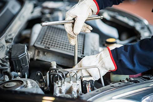 Mechanic at Work on Car Engine -  Comprehensive Auto Services in Charlottesville, VA