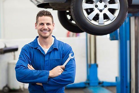 Mechanic Holding a Wrench -  Auto Repair and Maintenance Services in Charlottesville, VA