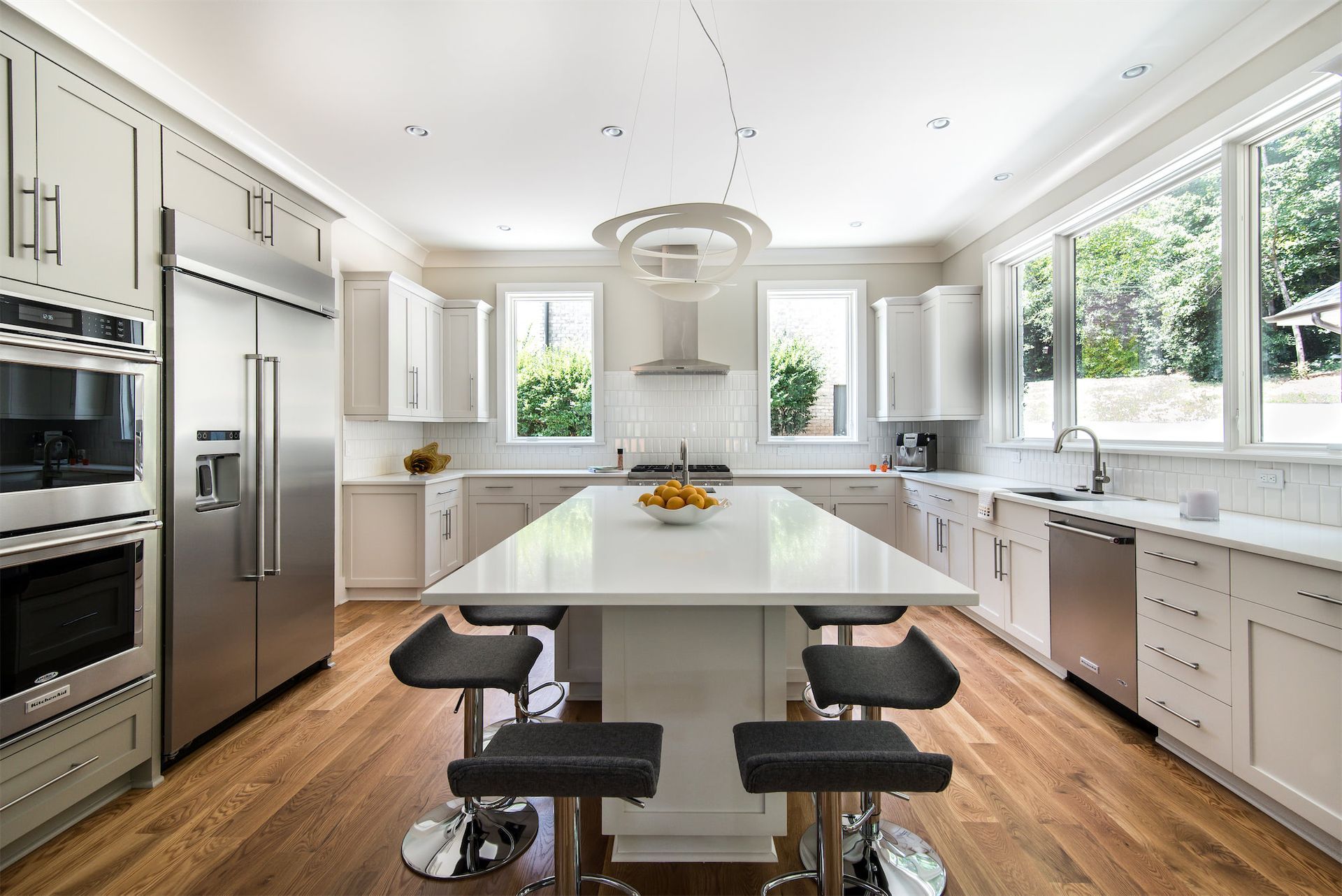 a kitchen with stainless steel appliances and a large island in the middle .