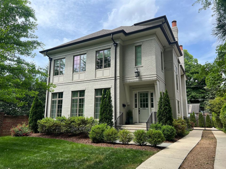 a transitional house with gray brick and a covered front porch